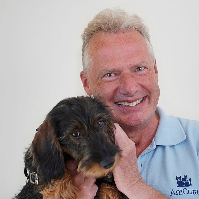 A person holding a dog.
