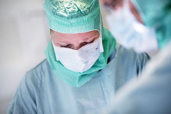 Nahaufnahme eines Arztes, der eine Maske trägt.