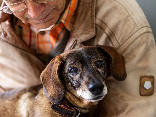 A person holding a dog.